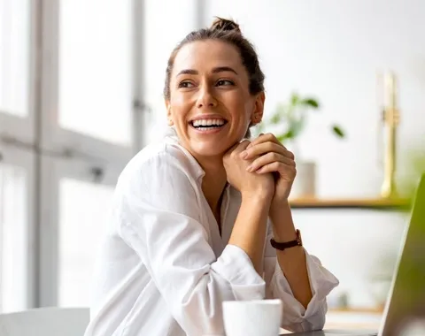 Young woman sitting at desk smiling