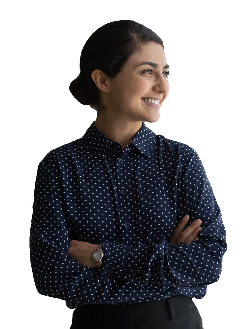 Young woman with dark hair pulled back into a low bun crossing her arms and smiling, looking to her left.