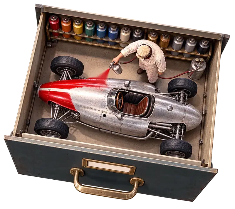 An image of a 1950's F1 car inside a filing cabinet drawer being painted red.