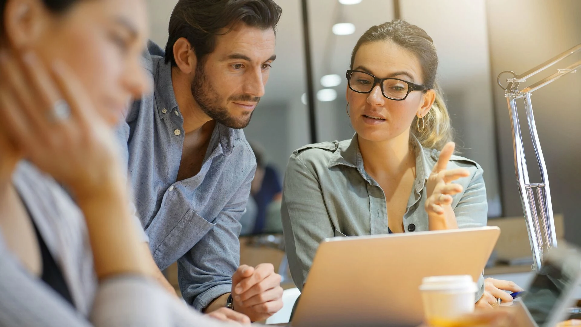 Group of people collaborating near laptop
