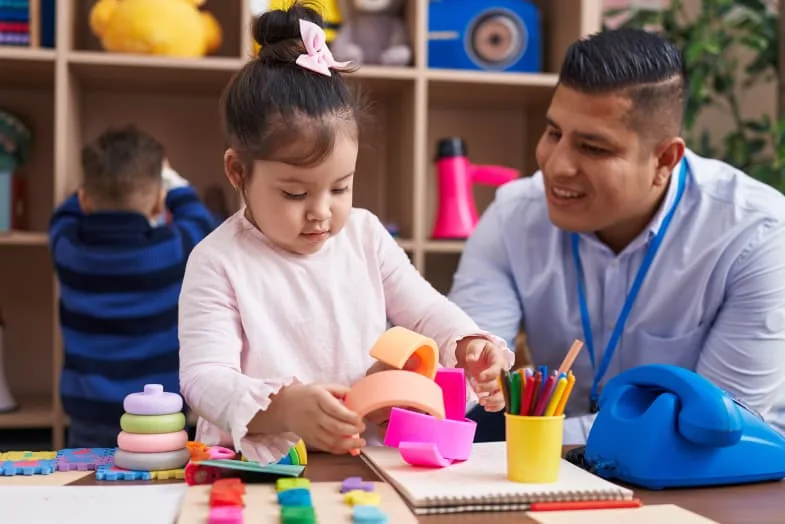 male teacher with preschool student