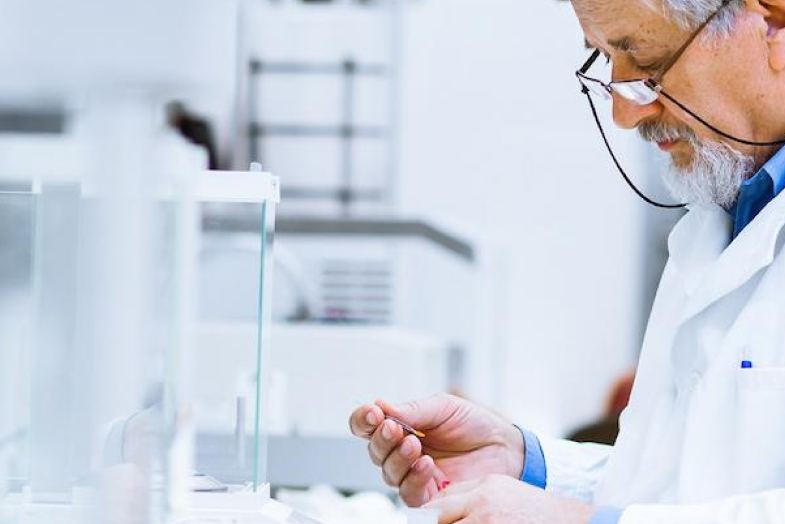 older male medical lab worker looking at test results