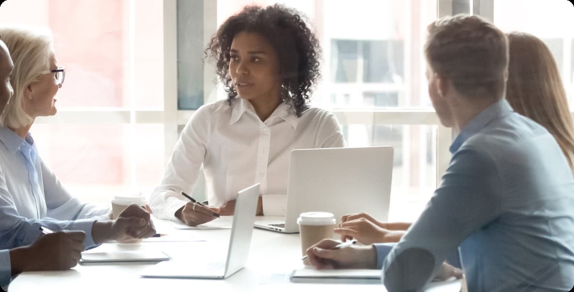 office worker colleagues sitting around conference table