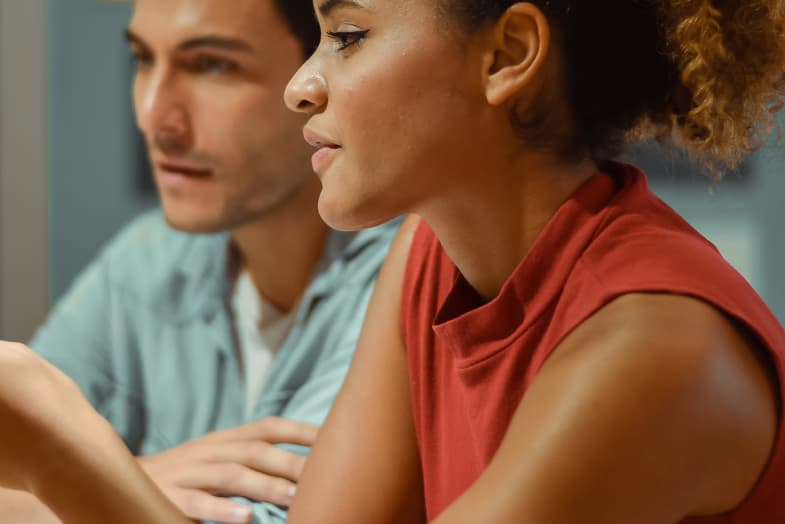 coworkers female and male sitting and working at computer