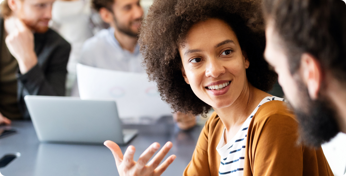 Young woman chatting with male coworker