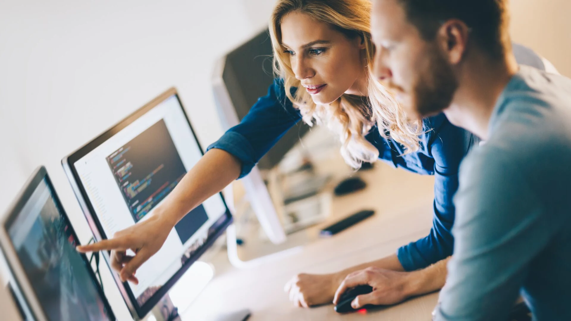 Man and Woman working together on code