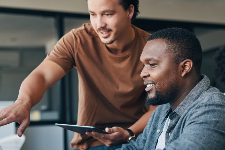 coworkers sitting at computer smiling