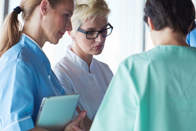 medical professionals standing around in a circle