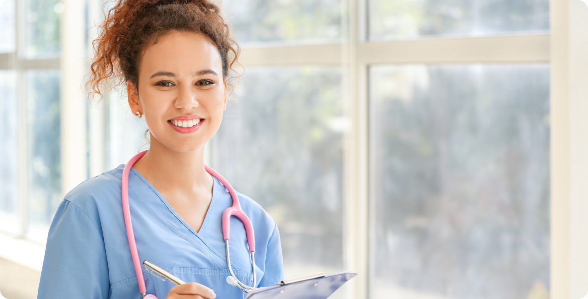 healthcare worker smiling with clipboard