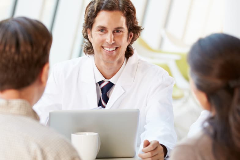 medical professionals sitting down at a meeting with eachother