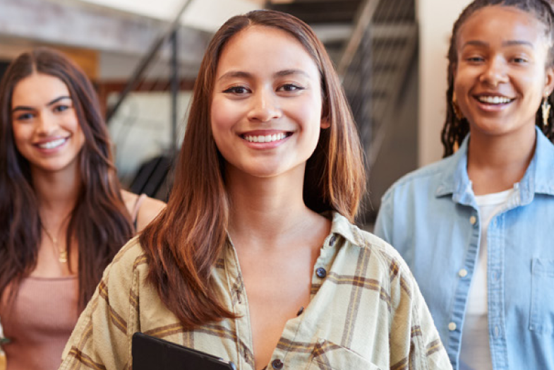 three retail colleagues smiling at camera