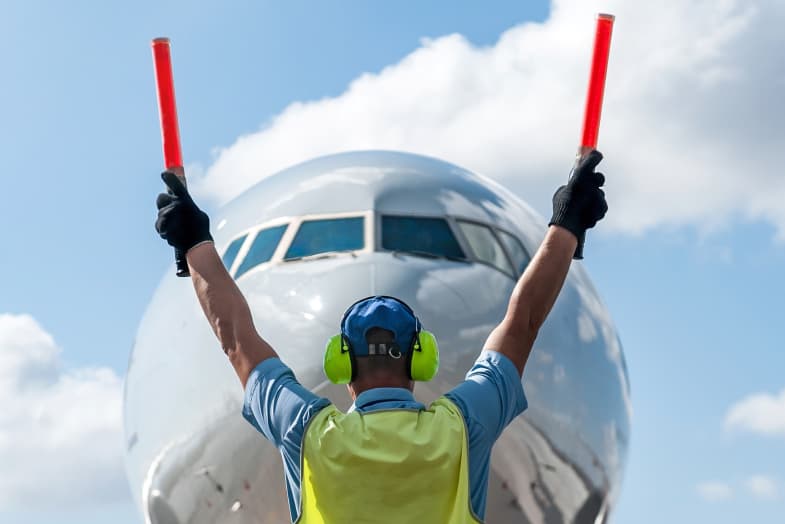 air traffic controller in front of airplane