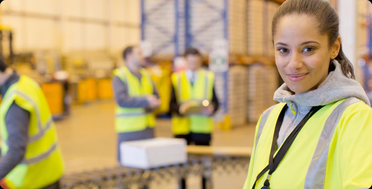 Employee in factory smiling at camera