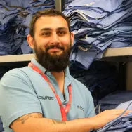 Image of Prince's Trust alum and Porter Dino, in the laundry room at a hospital