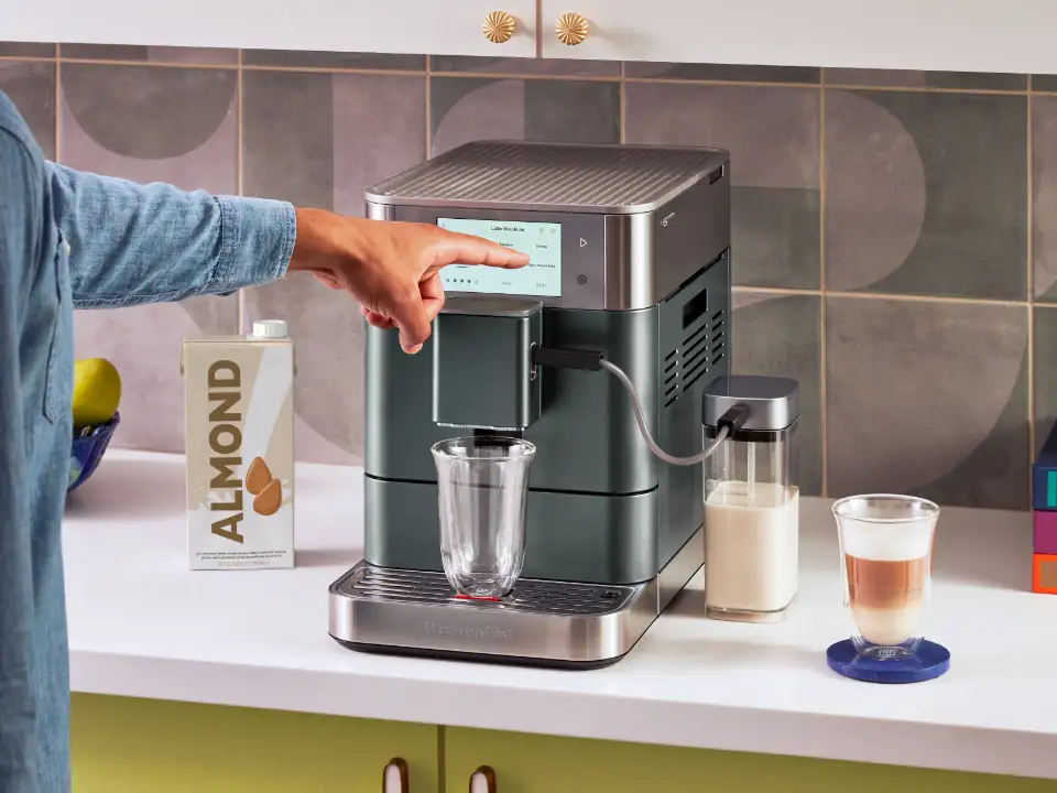 person-selecting-program-from-display-of-fully-automatic-coffee-machine