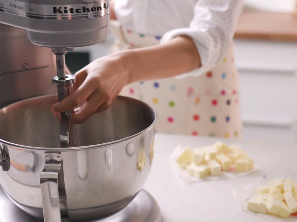 Accessories-pastry-beater-woman-fixing-pastry-beater-on-mixer-bowl-lift