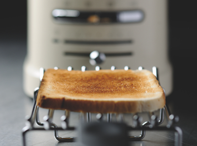 slice-of-bread-on-sandwich-rack-and-cream-toaster