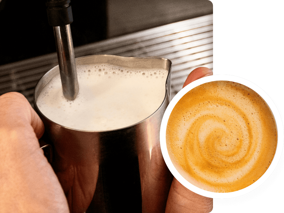 person-frothing-milk-with-coffee-machine-and-steam-wand-close-up