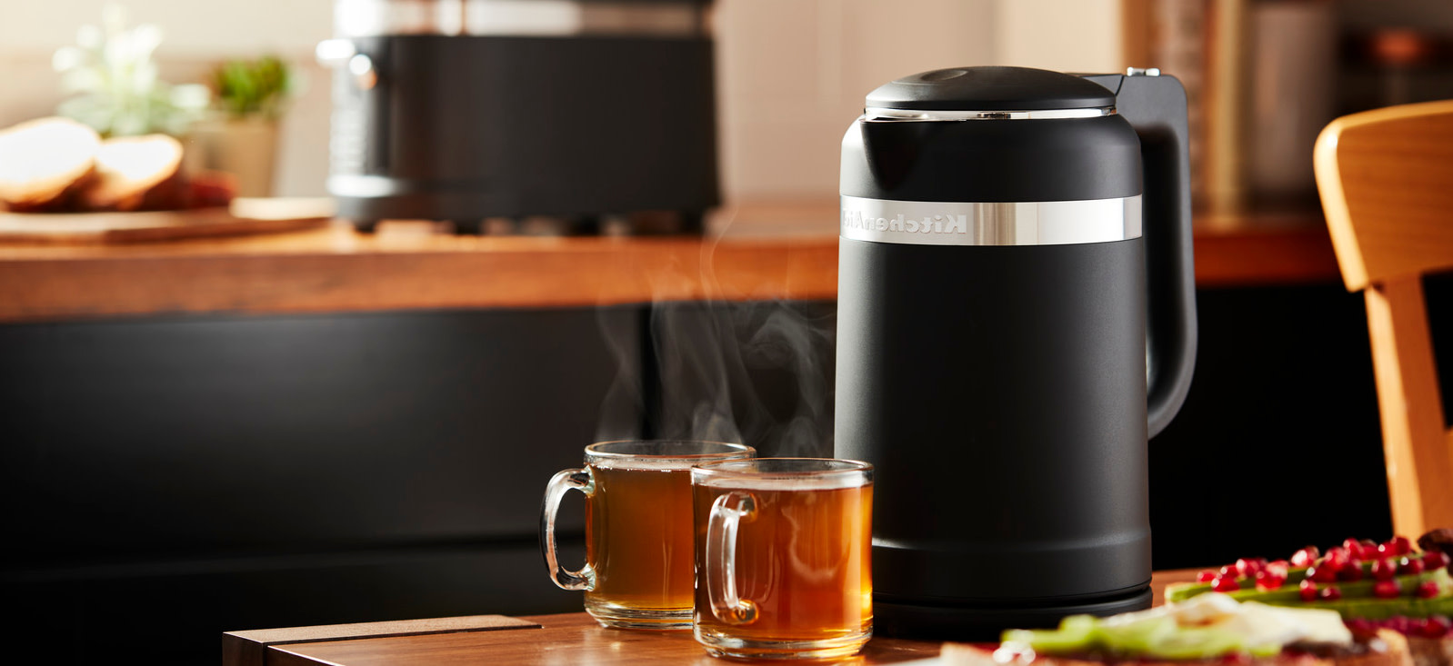 Black-electric-kettle-with-two-cups-of-hot-tea