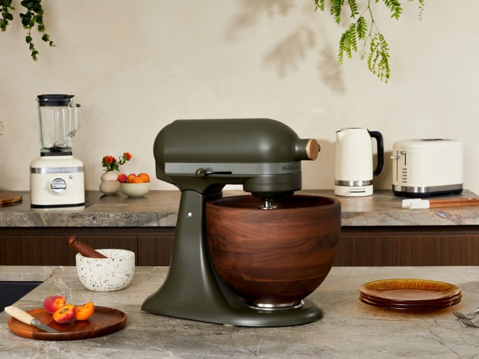 Evergreen-stand-mixer-stand-mixer-on-the-counter-top-surrounded-by-almond-cream-blender-kettle-and-toaster