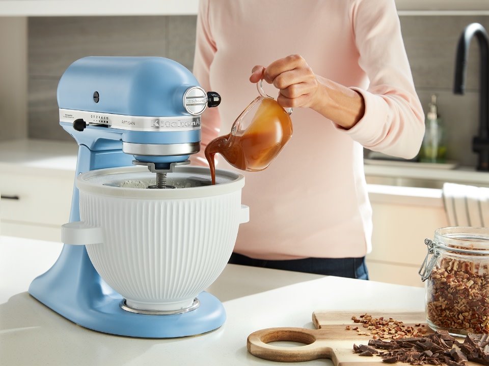 Mixer-attachments-ice-cream-maker-person-pouring-caramel-into-ice-cream-maker-bowl