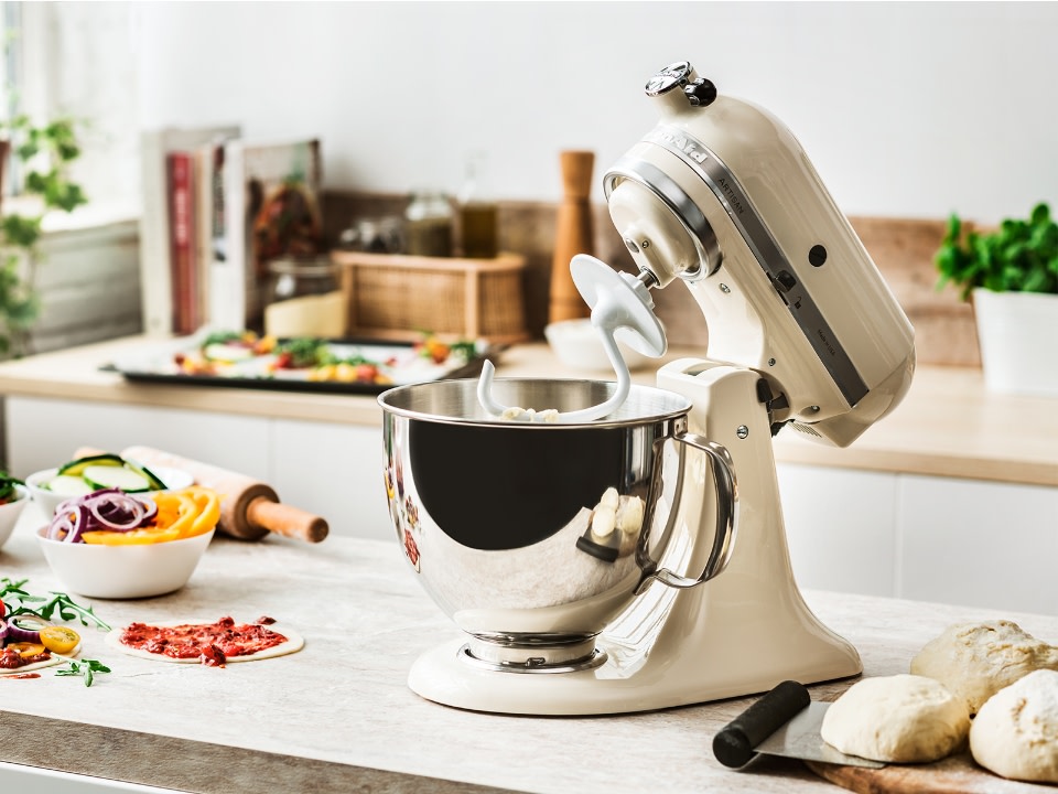 Mixer-parts-dough-hook-stand-mixer-and-dough-hook-next-to-pastry-on-a-kitchen-counter