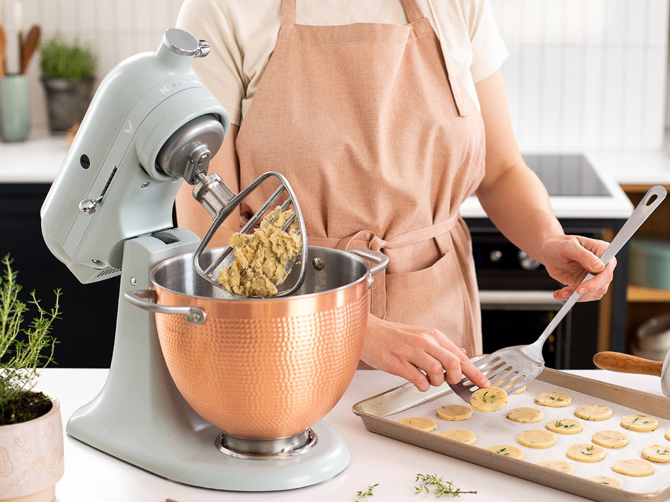 Mixers-tilt-head-47L-blossom-artisan-woman-in-the-kitchen-making-cookies-next-to-stand-mixer