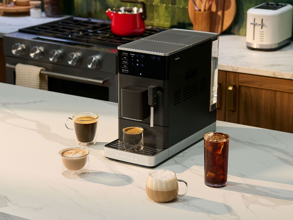 photo-left-right espresso-fully-auto-kf2 on-a-counter-surrounded-by-types-of-coffee