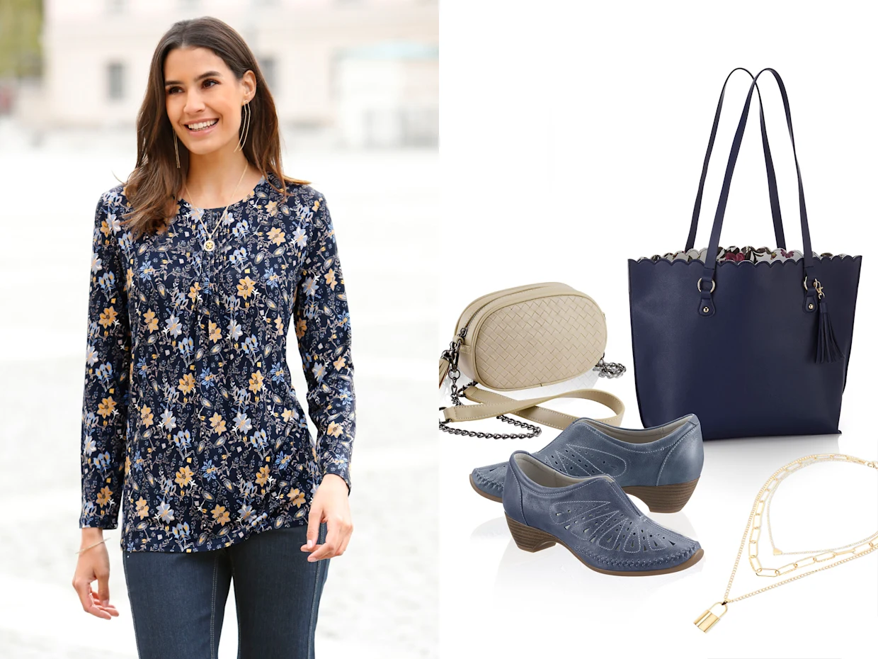 Dunkelblaues Langarmshirt mit floralem Muster, kombiniert mit dunkelblauen Jeans; daneben Accessoires wie blaue Tasche, beige Umhängetasche, blaue Schuhe und goldene Schmuckstücke.