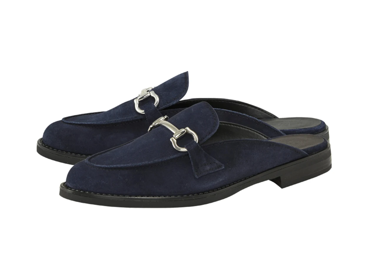 Dunkelblaue Loafer aus Veloursleder mit silberner Schnalle und flachem Absatz. Dunkelblaue Loafer aus Veloursleder mit silberner Schnalle und flachem Absatz.