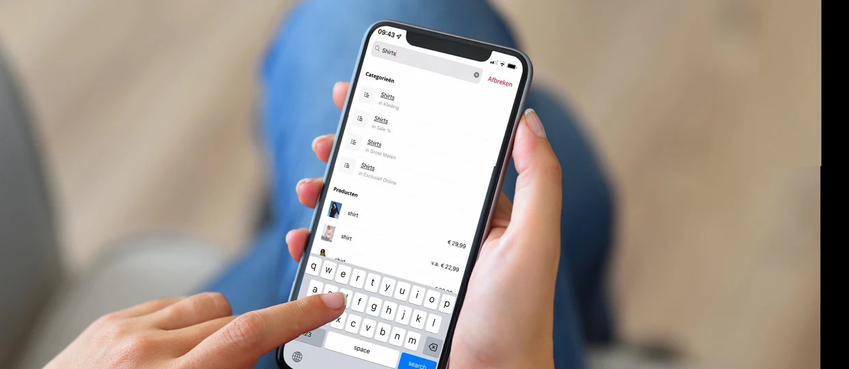 Hand die een smartphone vasthoudt met een winkelapp geopend op het scherm. Hand die een smartphone vasthoudt met een winkelapp geopend op het scherm.