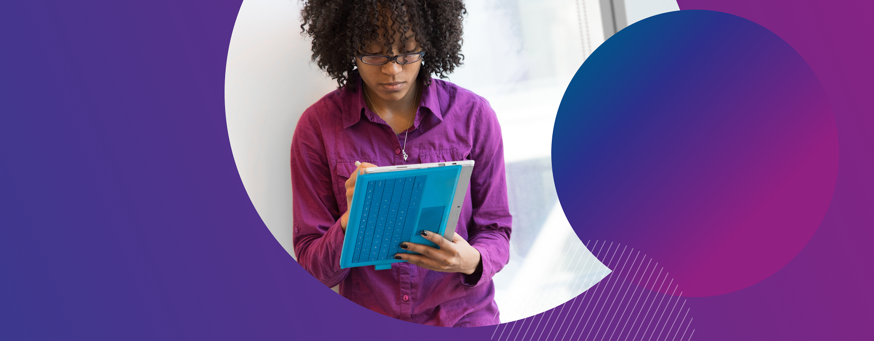 Young woman in a purple shirt holding a tablet