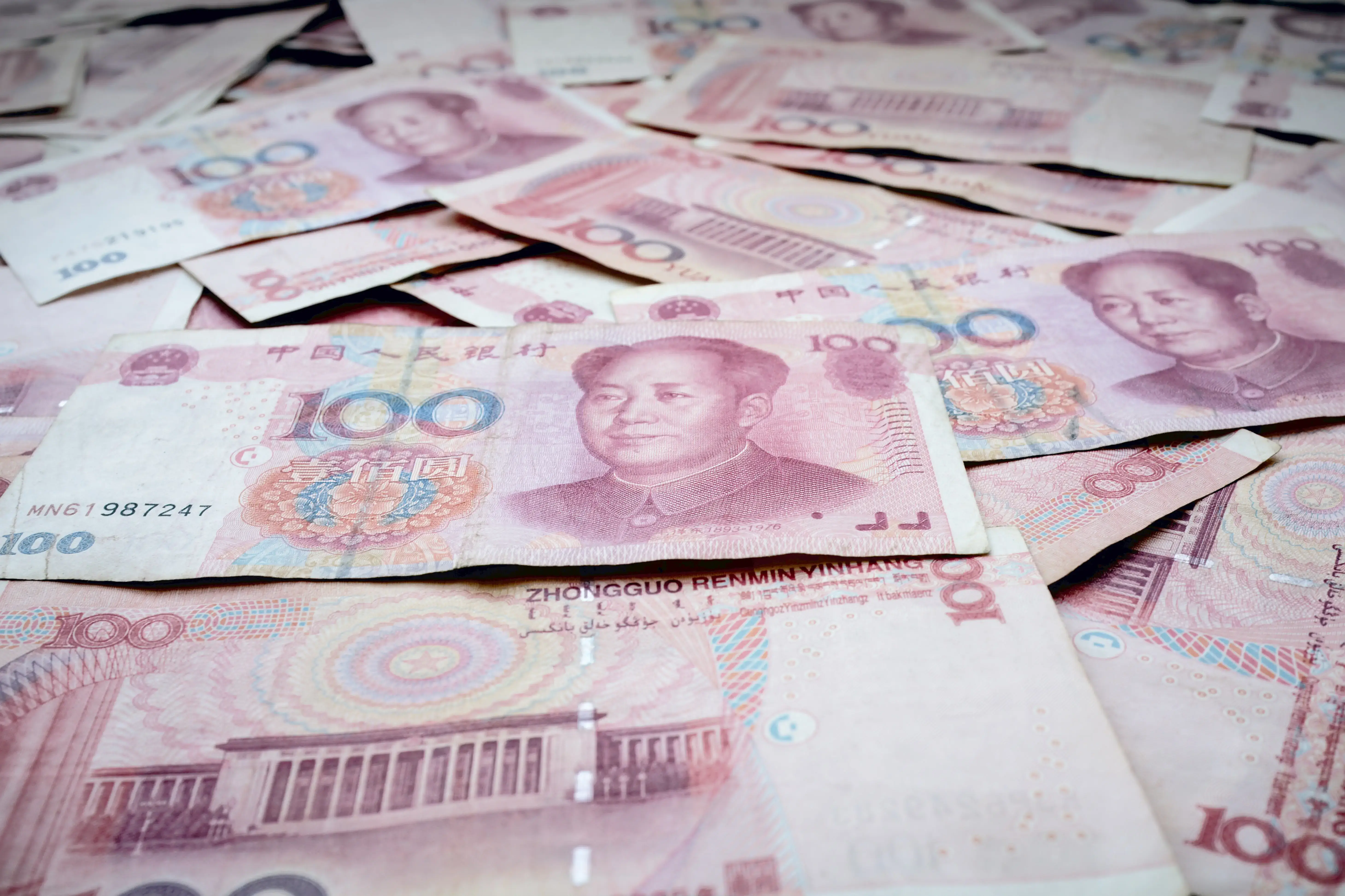 A close-up of a pile of 100 yuan bills