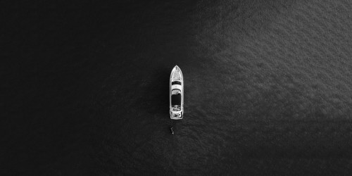 A monochrome boat in a sea.