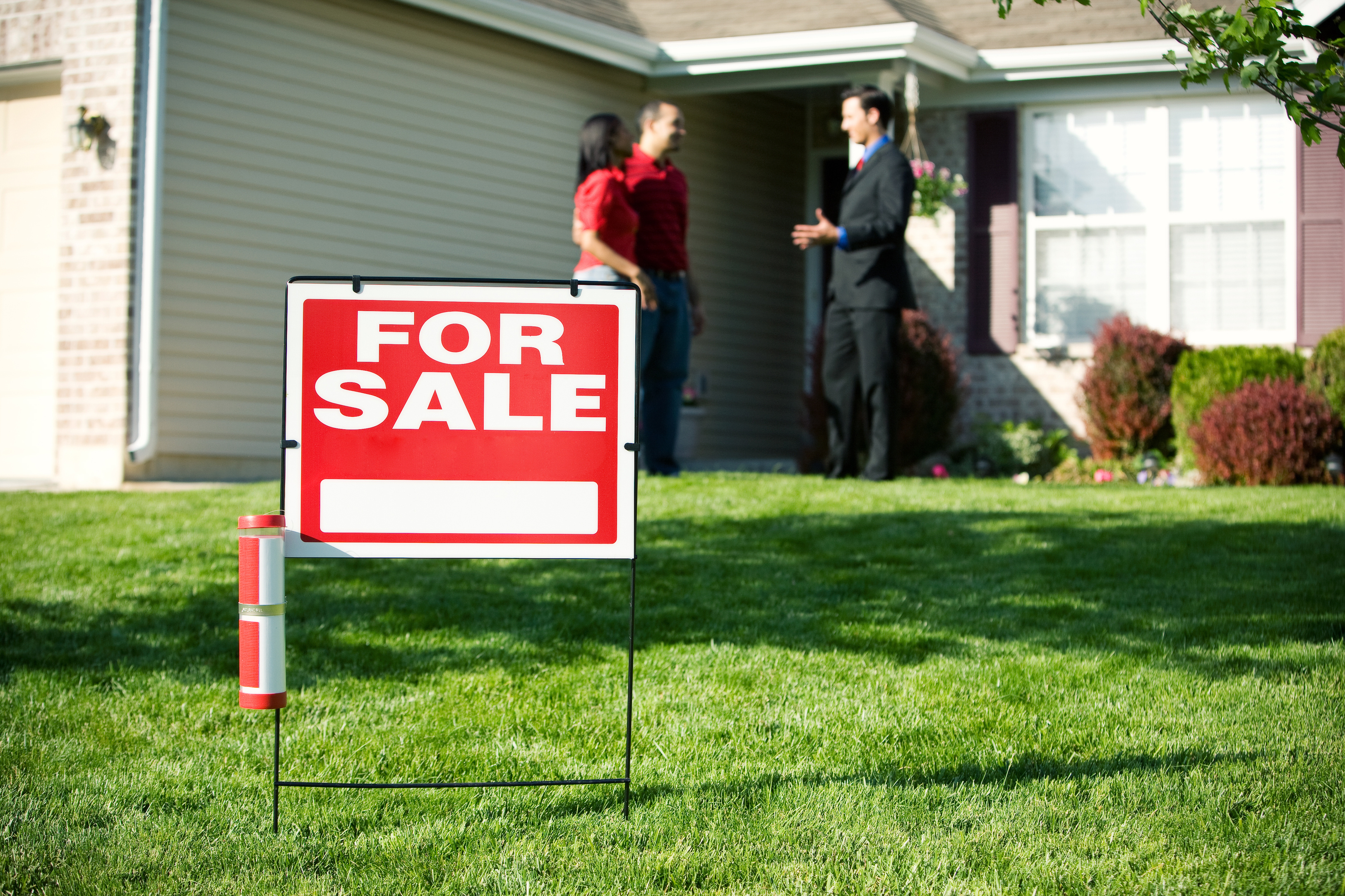 For sale sign in front of a house. 