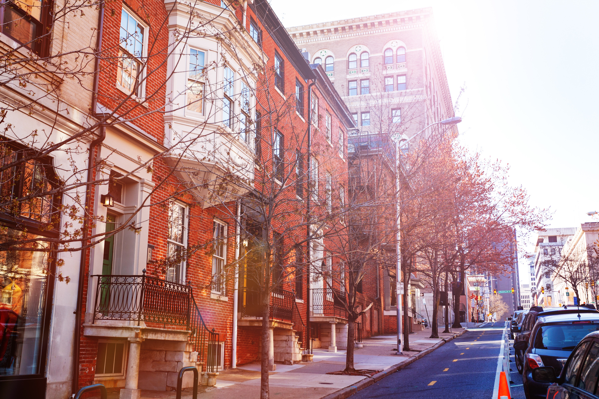 Image of a tree-lined residential street in downtown Baltimore.