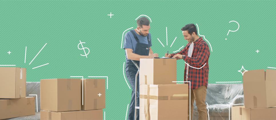 A man working for a moving company indicates a contract on top of a stack of boxes to another man. 