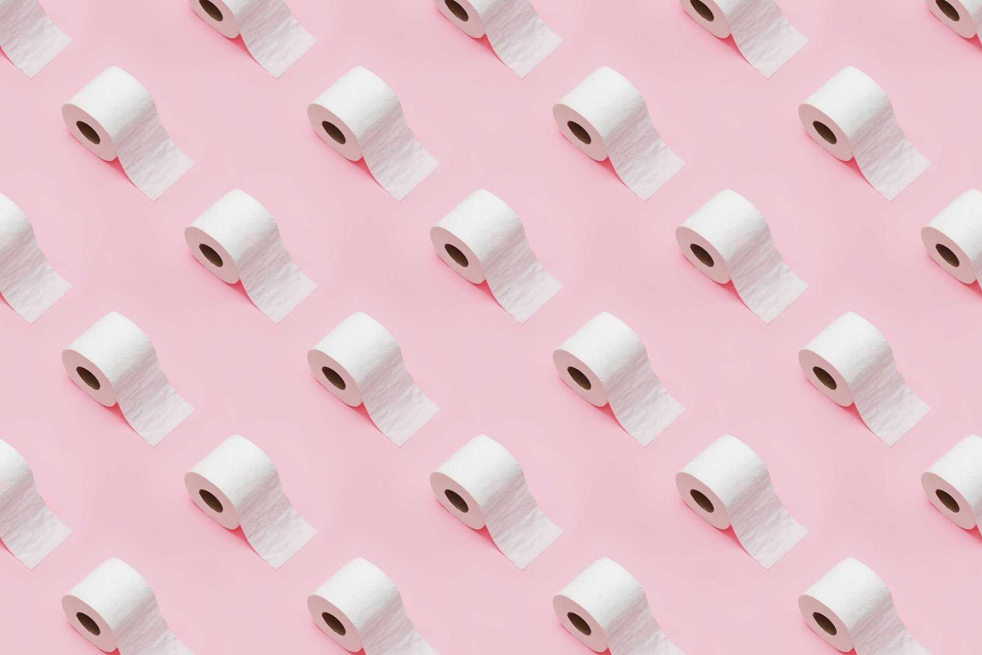 repeating rolls of toilet paper on pink background
