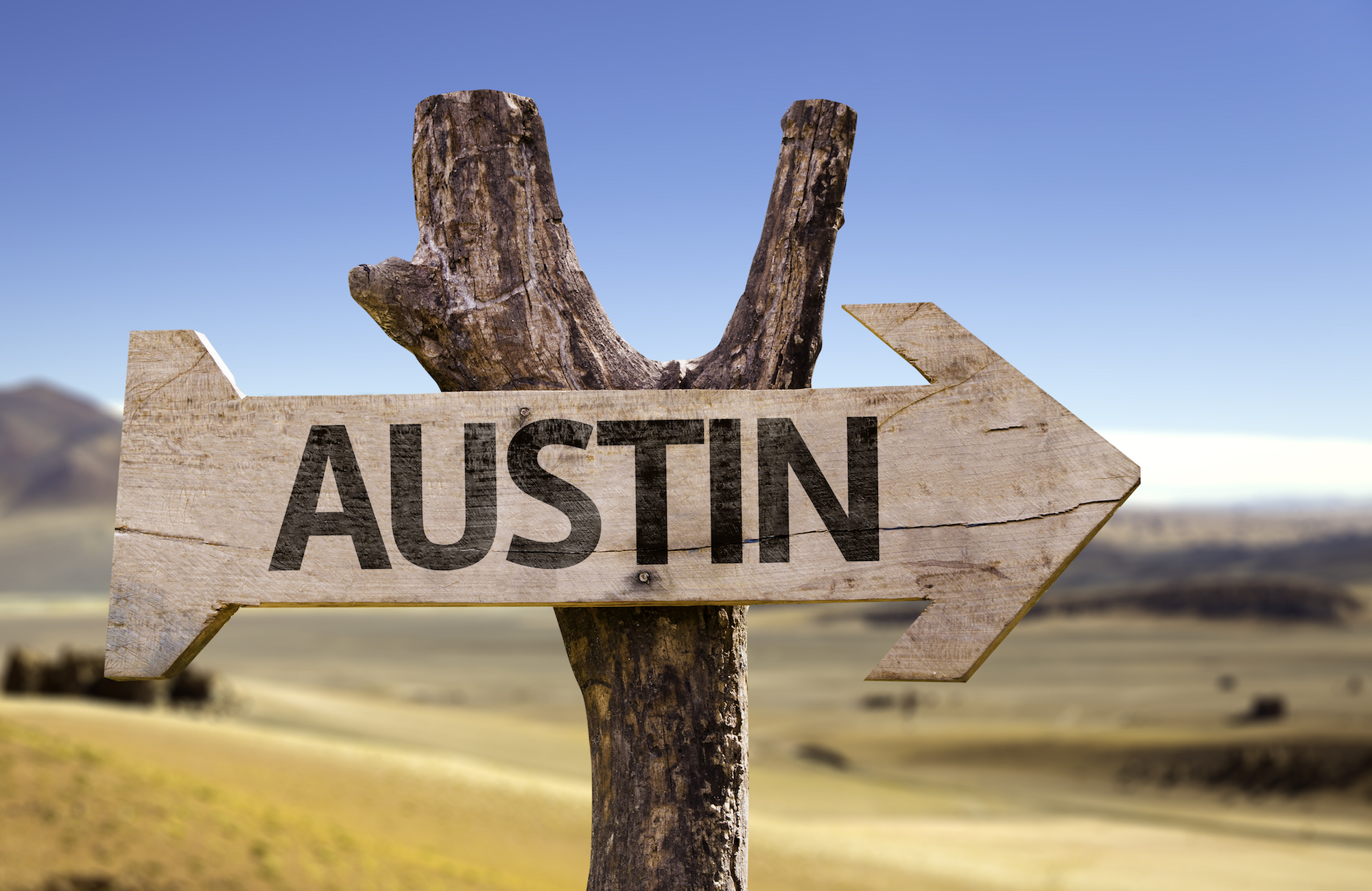 Sign in the shape of an arrow pointing right reads "Austin".