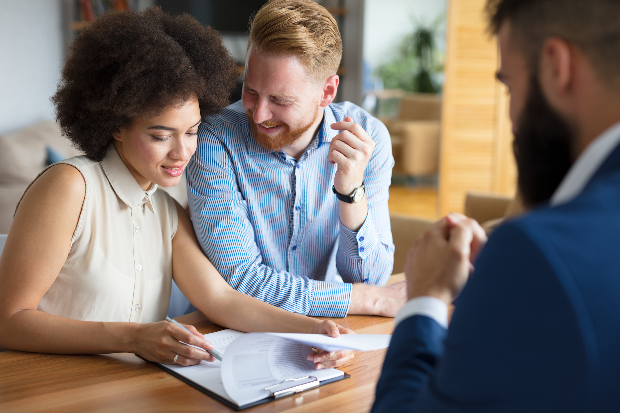 Couple looks over documents with an agent.