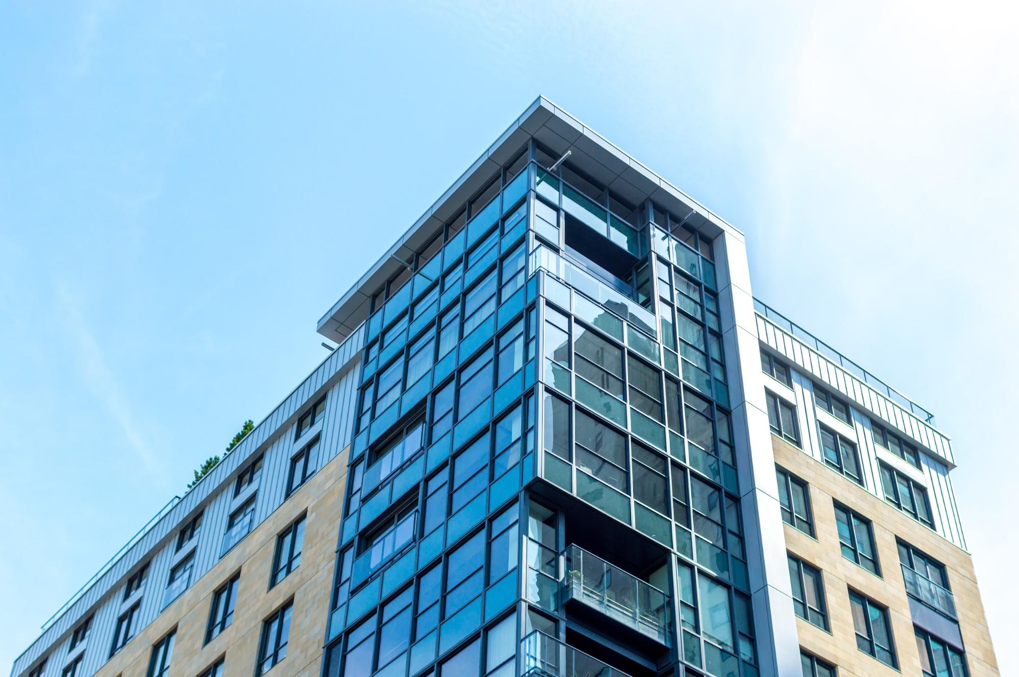 A condominium building against a blue sky