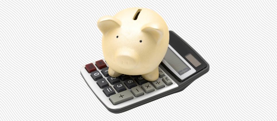 Piggy bank on top of a calculator.