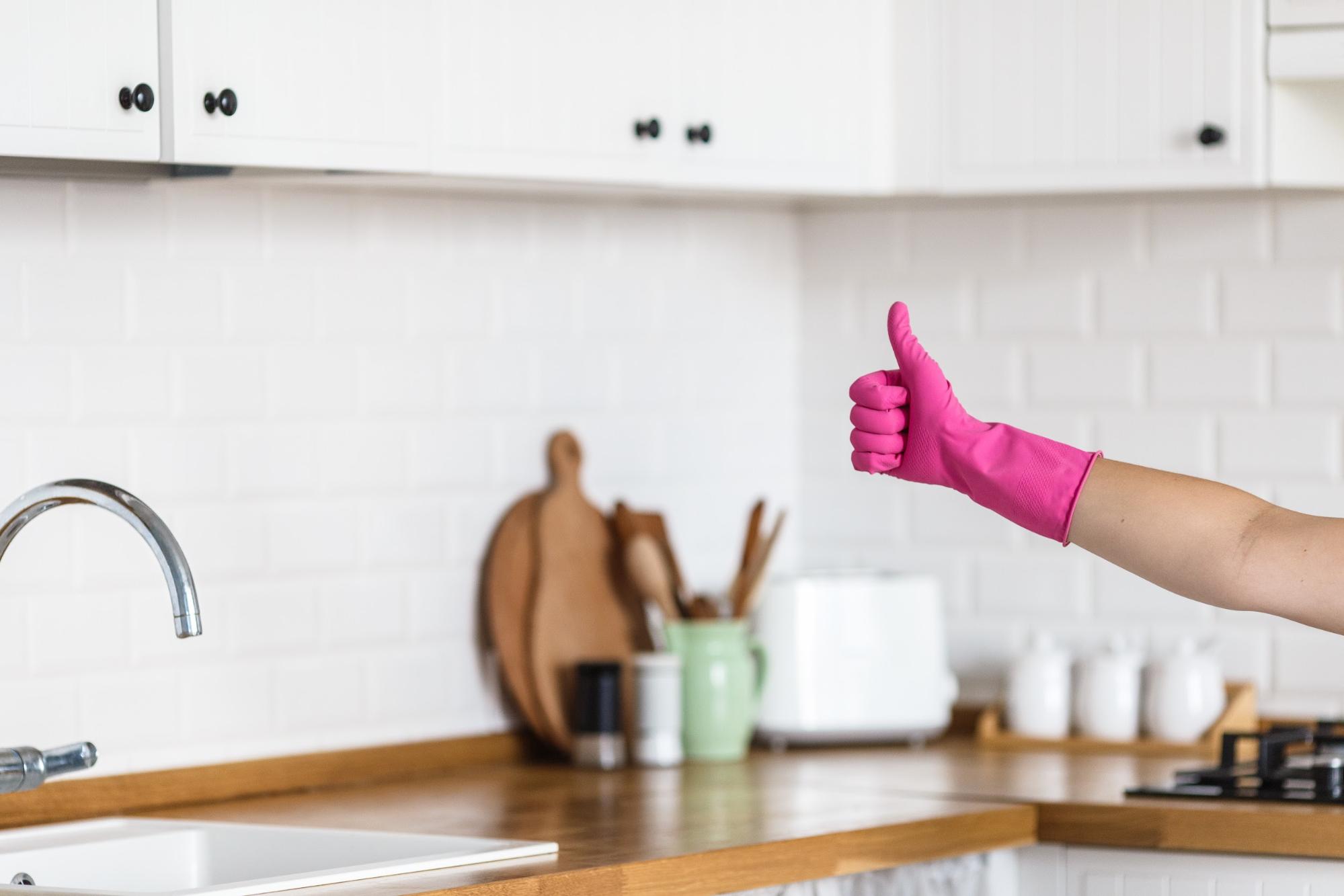 pink rubber glove with a thumbs up 