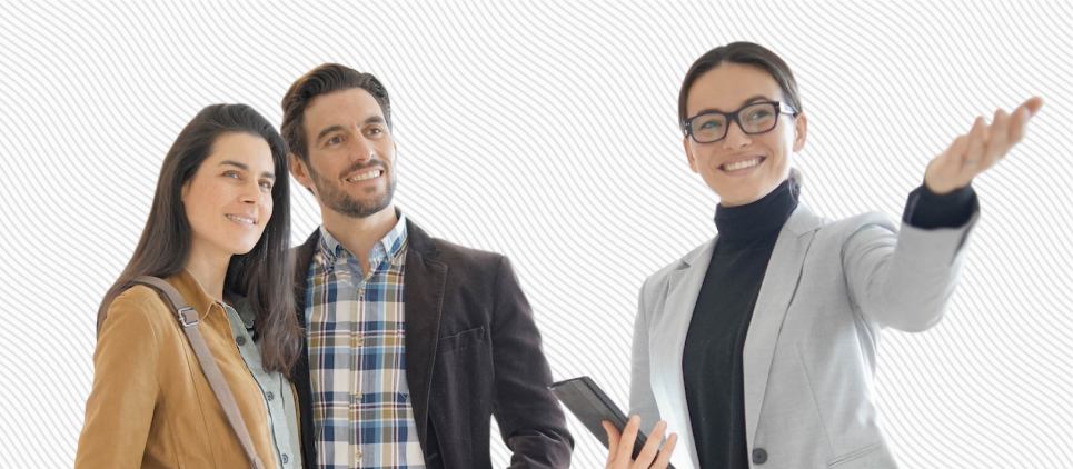 Real estate agent shows two prospective buyers a home. 