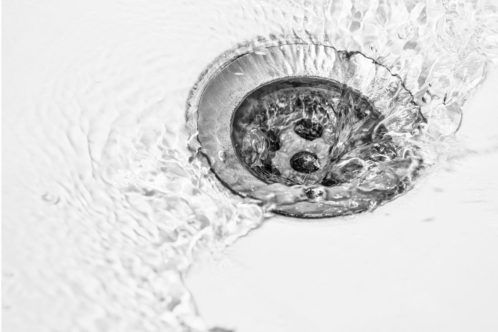 circular drain with water rushing down 