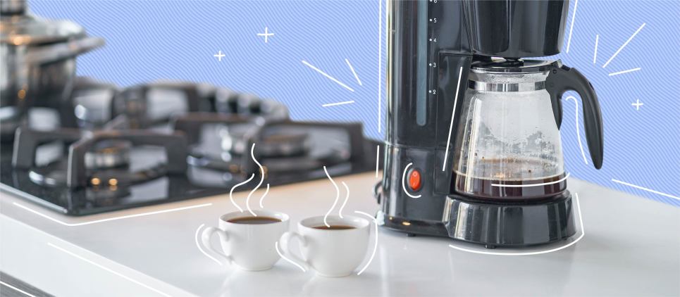 coffee maker with two cups of coffee on kitchen counter top next to stove 