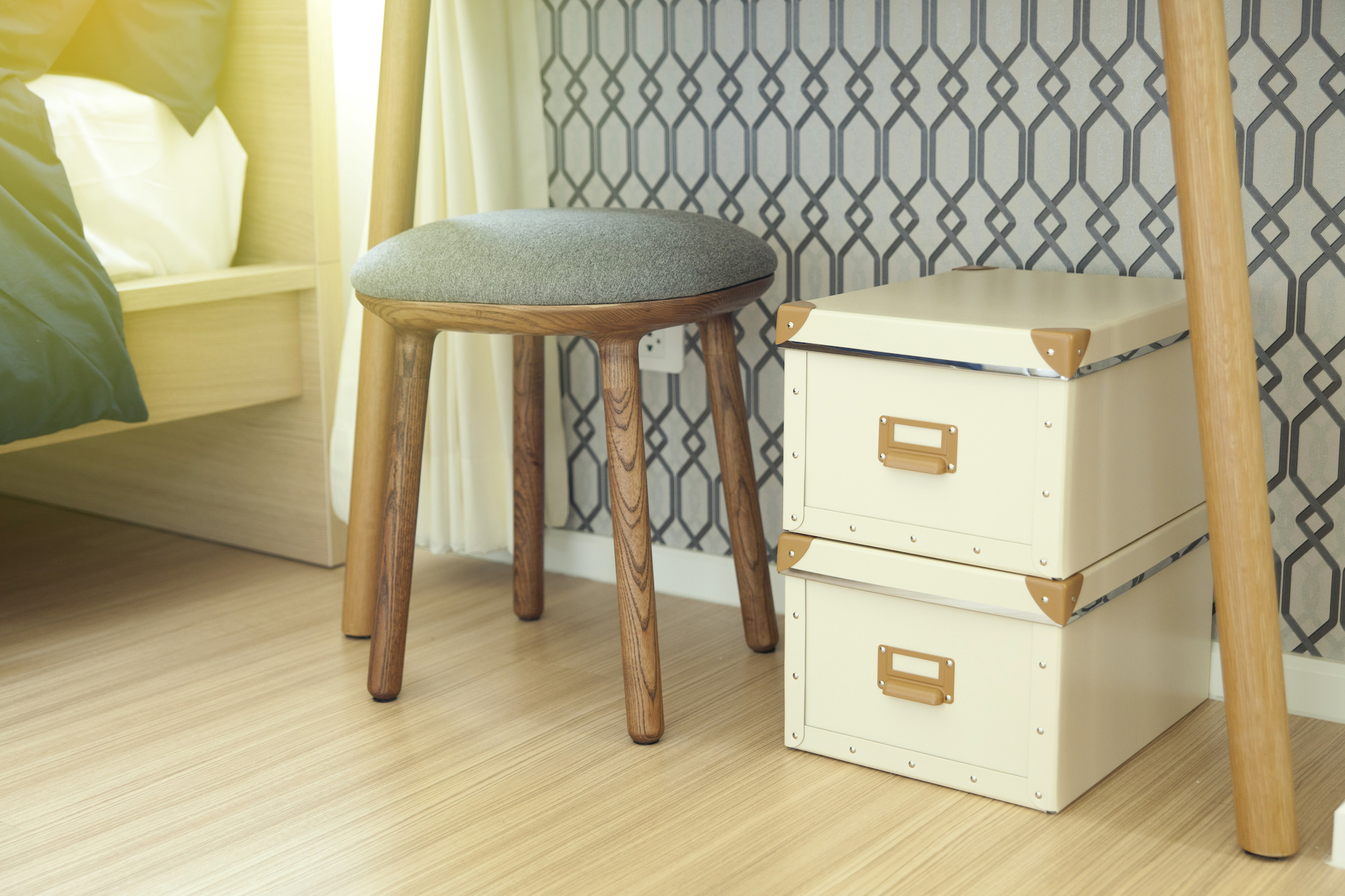 Two small storage boxes sit under a side table.