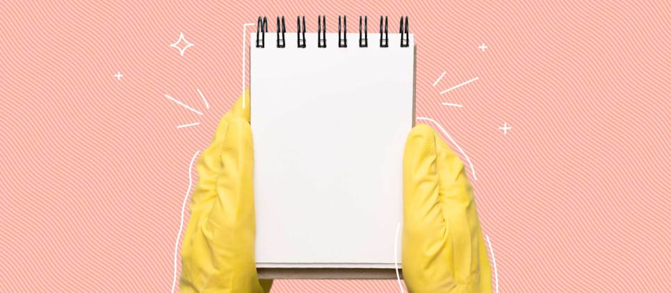 yellow rubber gloves holding note pad on pink background 