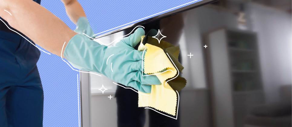 person with light blue glove wiping down tv screen with yellow rag 