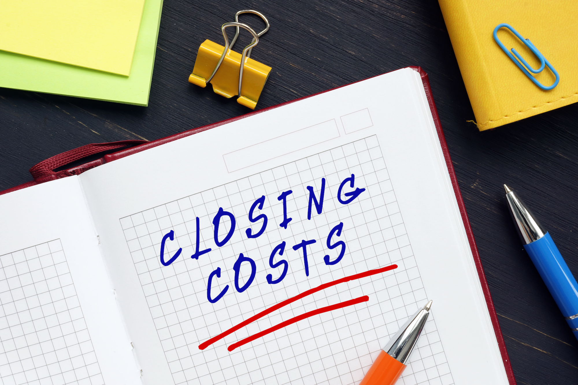 Notebook with "closing costs" written in blue ink.